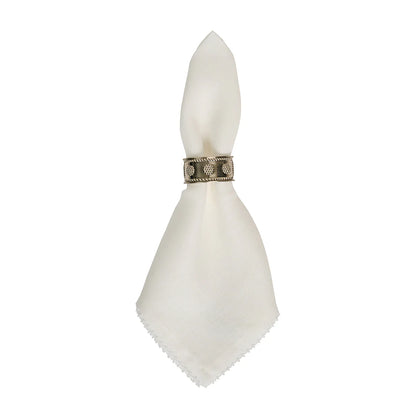 The Berry Scallop Napkin Set by Juliska features white woven linen napkins, each secured with a decorative metal ring, displayed against a plain white background.