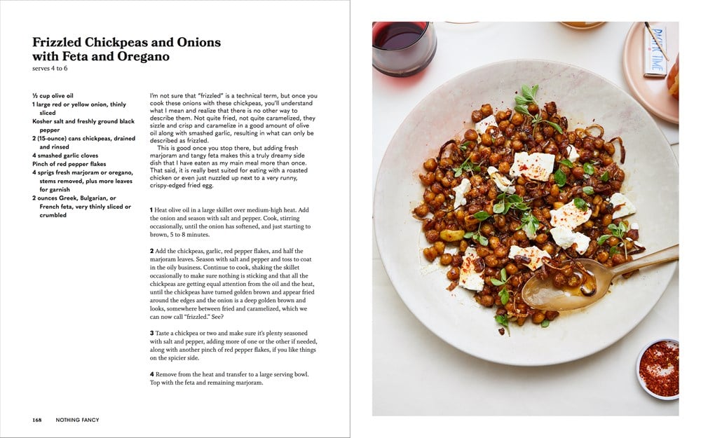 A recipe page from a cookbook titled "Nothing Fancy: The Art of Having People Over by Common Ground," showcasing impromptu dinner ideas with ingredients, cooking instructions, and a photo of the dish—a visually stunning bowl of chickpea salad with feta cheese.
