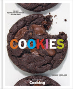 Close-up of three Penguin Random House Cookies on a white background, one with a bite taken out, with the word “COOKIES” in colorful text across the center—a mouthwatering dessert moment inspired by NYT Cooking.