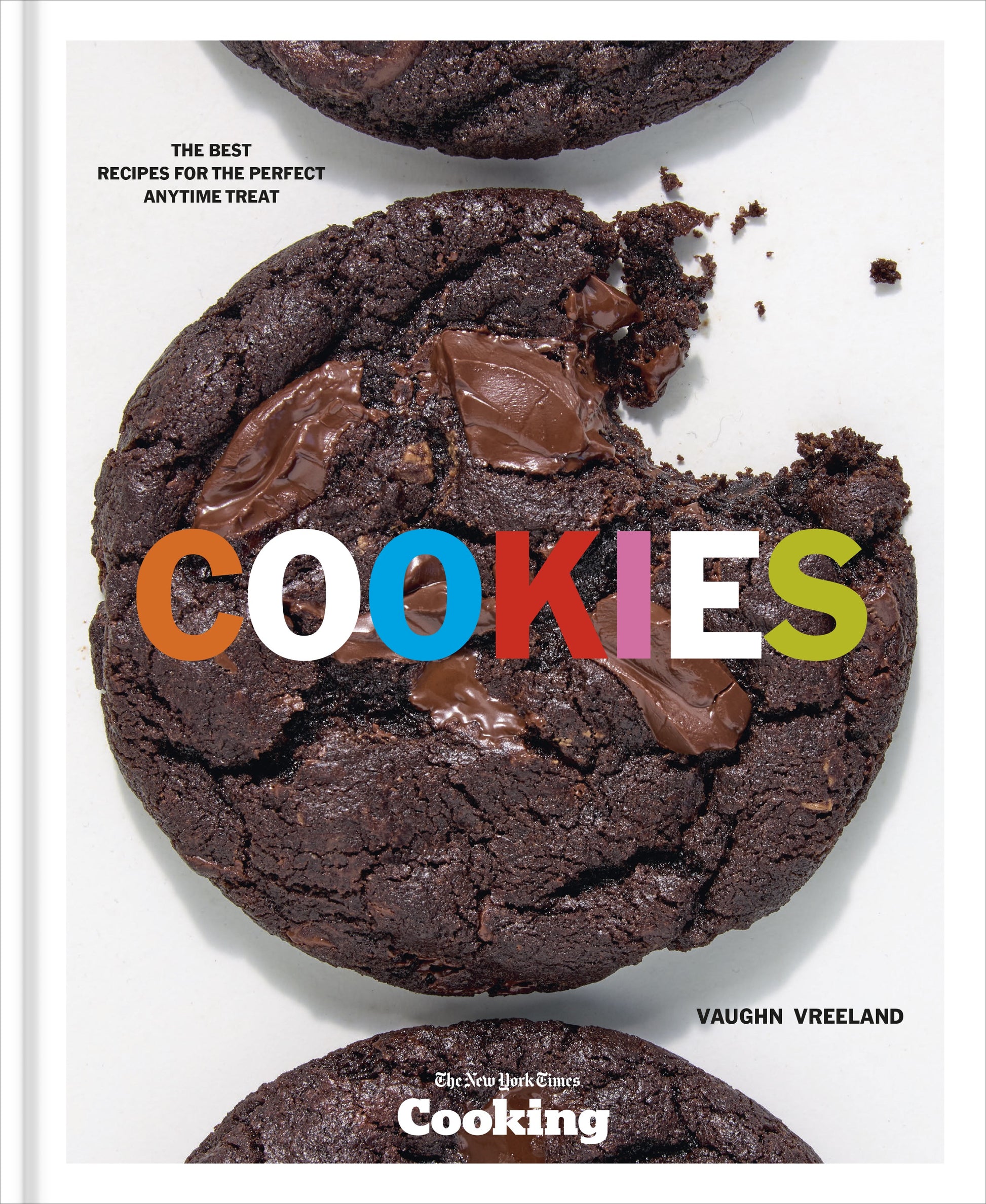 Close-up of three Penguin Random House Cookies on a white background, one with a bite taken out, with the word “COOKIES” in colorful text across the center—a mouthwatering dessert moment inspired by NYT Cooking.