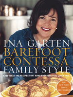 Ina Garten beams behind a table displaying a pastry adorned with orange slices; the cover of Barefoot Contessa Family Style by Penguin Random House highlights her distinctive take on approachable, everyday cuisine.