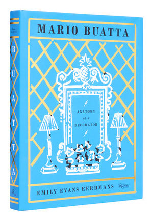 The book cover of "Mario Buatta: Anatomy of a Decorator" by Rizzoli, designed by Emily Evans Eerdmans, showcases a decorative frame with two lamps on a light blue background accented in gold, reflecting Mario Buatta's maximalist interior style.