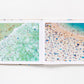 An open Beaches photography book by Gray Malin showing an aerial view of swimmers in ocean waves on the left page and sunbathers on a sandy beach on the right page.
