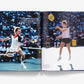 Two male tennis players compete in a championship match on a hard court as spectators watch, captured in "US Open: 50 Years of Championship Tennis" by Abrams.