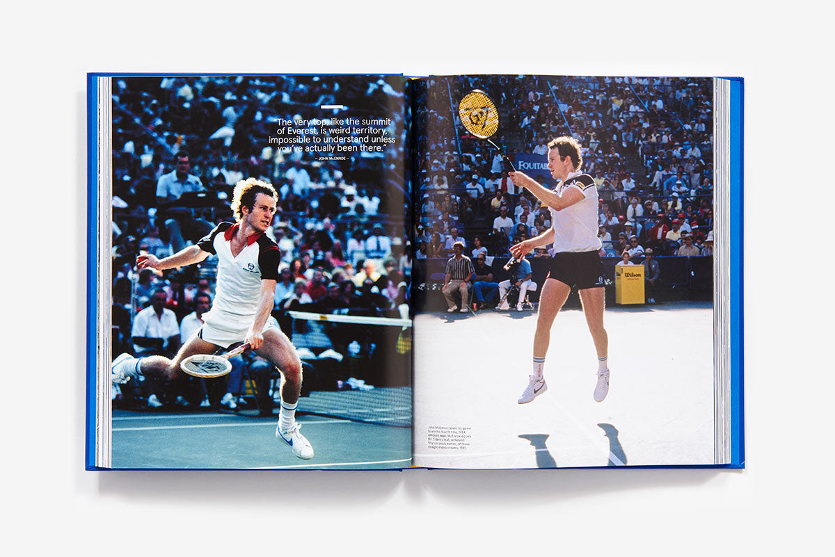 Two male tennis players compete in a championship match on a hard court as spectators watch, captured in "US Open: 50 Years of Championship Tennis" by Abrams.