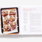 Open Home Made Christmas cookbook showing a recipe for brioche and red fruit swirls with ricotta glaze, featuring a photo of five baked rolls on a tray.