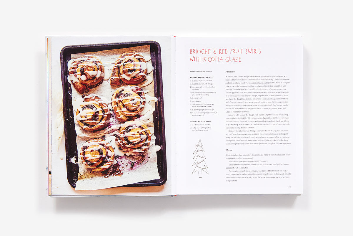 Open Home Made Christmas cookbook showing a recipe for brioche and red fruit swirls with ricotta glaze, featuring a photo of five baked rolls on a tray.