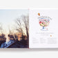 An open Home Made Christmas cookbook showing a photo of a snowy house at sunset on the left and a champagne bowl recipe with an illustration of the drink on the right.