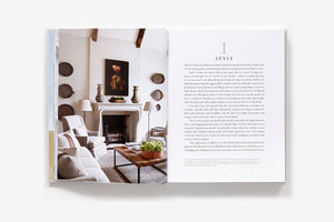Open book of Atmosphere: The Seven Elements of Great Design, showing a neutral-toned living room photo on the left page and a chapter titled “Style” on the right.