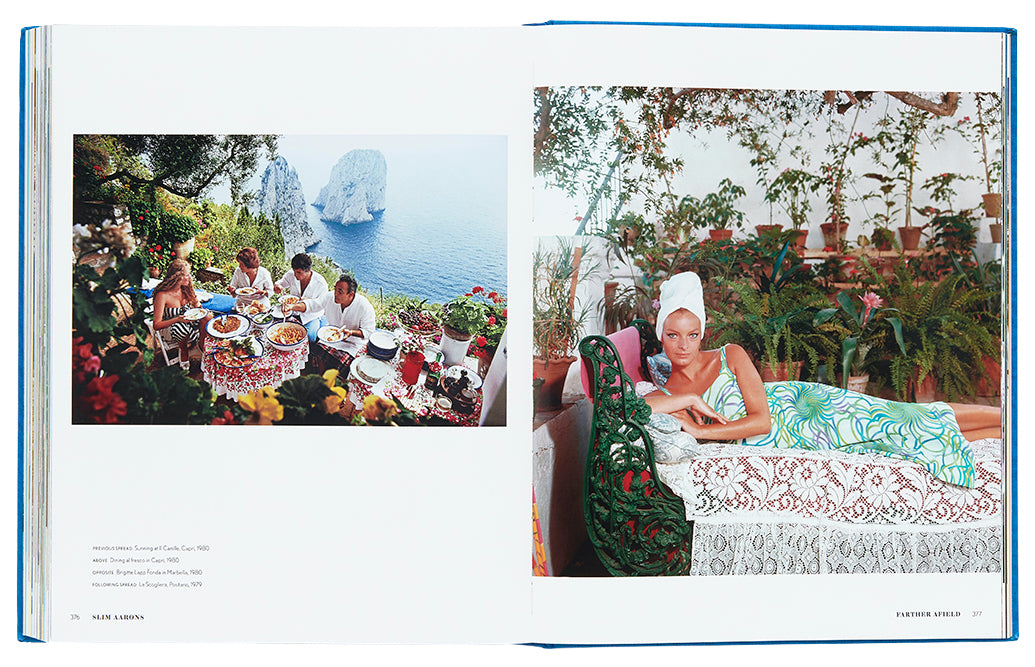 Two-page spread in a book showing a coastal dining scene on the left and a woman relaxing on a chaise lounge on the right, captured in the distinctive Slim Aarons style from "Slim Aarons: The Essential Collection" by Abrams.