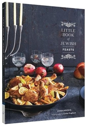 The "Little Book of Jewish Feasts" by Leah Koenig and published by Chronicle Books features a vibrant cover with photos of a table set with roasted chicken, vegetables, pomegranates, and candles. This curated book celebrates Jewish culinary traditions and holiday dishes.