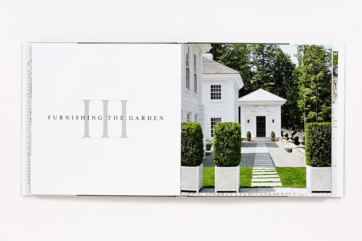 An open book, "Bunny Williams: On Garden Style" by Abrams, shows the title on the left and a photo of a formal garden entrance with hedges and a white house—evoking Bunny Williams' signature design—on the right page.