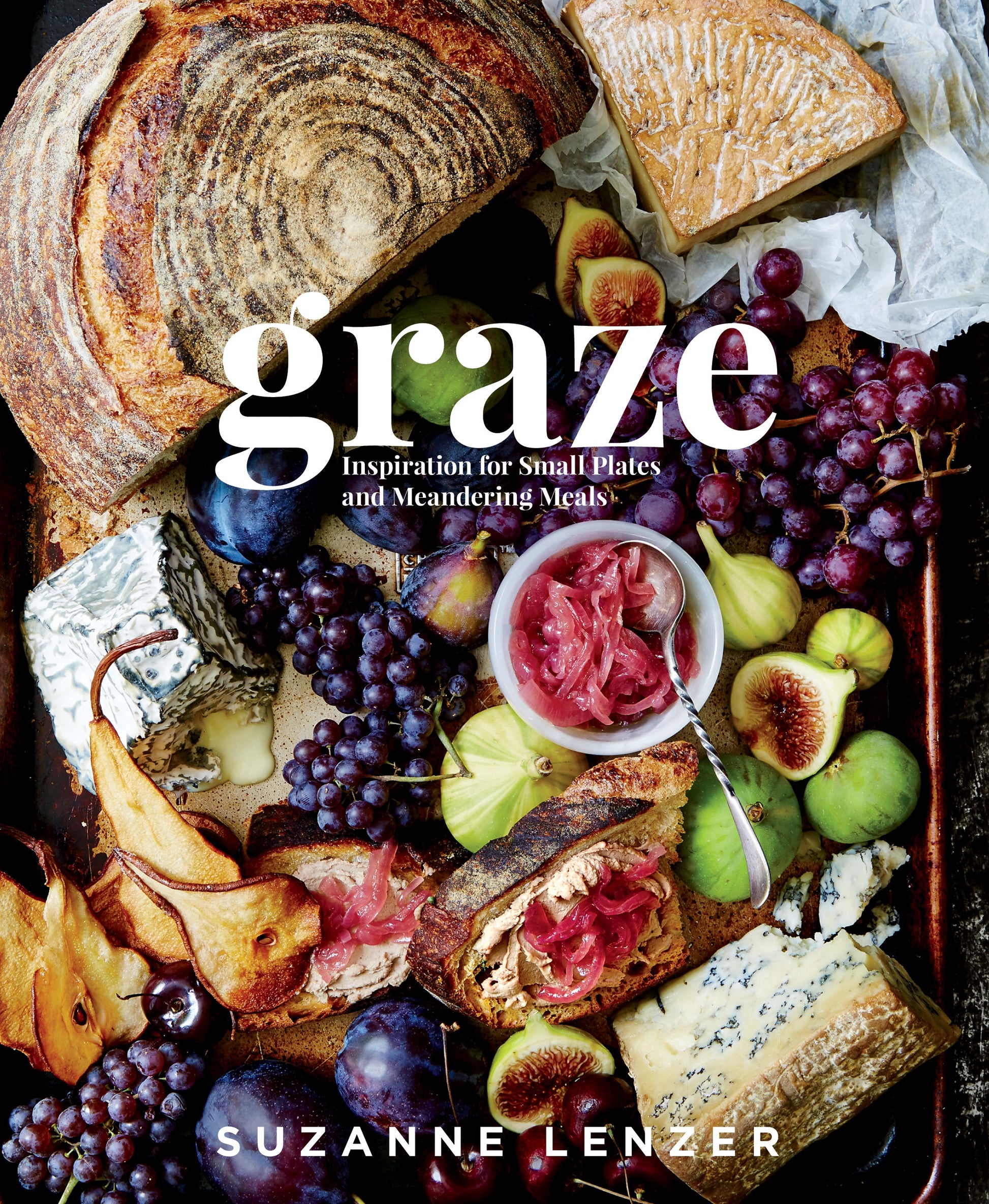 A selection of cheeses, grapes, figs, pears, bread, and pickled onions is artfully arranged on a tray in classic tapas style; the product name “Graze” and the brand “Penguin Random House” are displayed as text over the image.