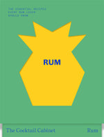 A bold yellow geometric pineapple shape stands out against a green background, featuring the blue-lettered title “The Cocktail Cabinet: Rum” from Penguin Random House, alongside text highlighting essential rum cocktails and classic cocktail recipes.