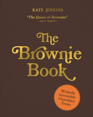 Sure! Here is your rewritten sentence using the product data: “The Brownie Book by Kate Jenkins from Penguin Random House features a brown cover with gold lettering and an orange sticker reading ‘Wickedly Irresistible Chocolatey Treats.’ Inside, you’ll find an array of tempting brownie recipes—including chocolate brownies and blondies—perfect for every dessert lover.”.
