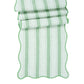 The Juliska Cabana Stripe Tabletop Collection features a breezy linen table runner with scalloped trim and accordion-folded cabana stripes.