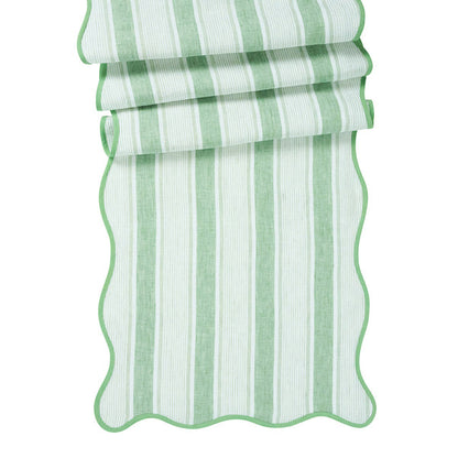 The Juliska Cabana Stripe Tabletop Collection features a breezy linen table runner with scalloped trim and accordion-folded cabana stripes.