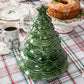 The Juliska Berry & Thread Basil Christmas Tree Cookie Jar makes a charming centerpiece on a plaid tablecloth, surrounded by Berry & Thread holiday dishes, cake, and coffee.