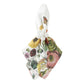 The Field of Flowers White Napkin Set by Juliska features elegant white linen napkins adorned with vibrant floral and butterfly prints, each elegantly secured with a white ring accented by a cluster of circular embellishments. Perfect for any occasion, these sophisticated napkins bring charm and bold style to your table setting.