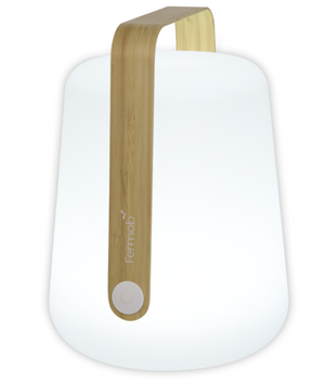 The Bamboo Balad 15" Lamp by Fermob is a modern white lamp with a wooden handle, round button, and Fermob logo—ideal for portable lighting and outdoor use.