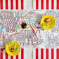 A Gingerbread Partyware Collection table runner with gingerbread house illustrations, markers, and two yellow plates of hard candies as festive accents.