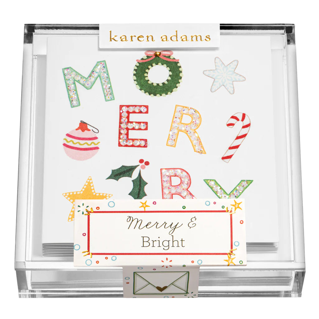 Karen Adams Holiday Acrylic Gift Enclosures feature festive "MERRY" letters with holiday designs and a “Merry & Bright” label—a charming holiday gift to spread seasonal cheer.