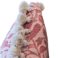 Close-up of the Peacock Garden Pillow by Hive Custom Pillows, showcasing a vibrant red floral pattern and a row of white tassels along the edge, with a hidden zipper closure for a seamless look.