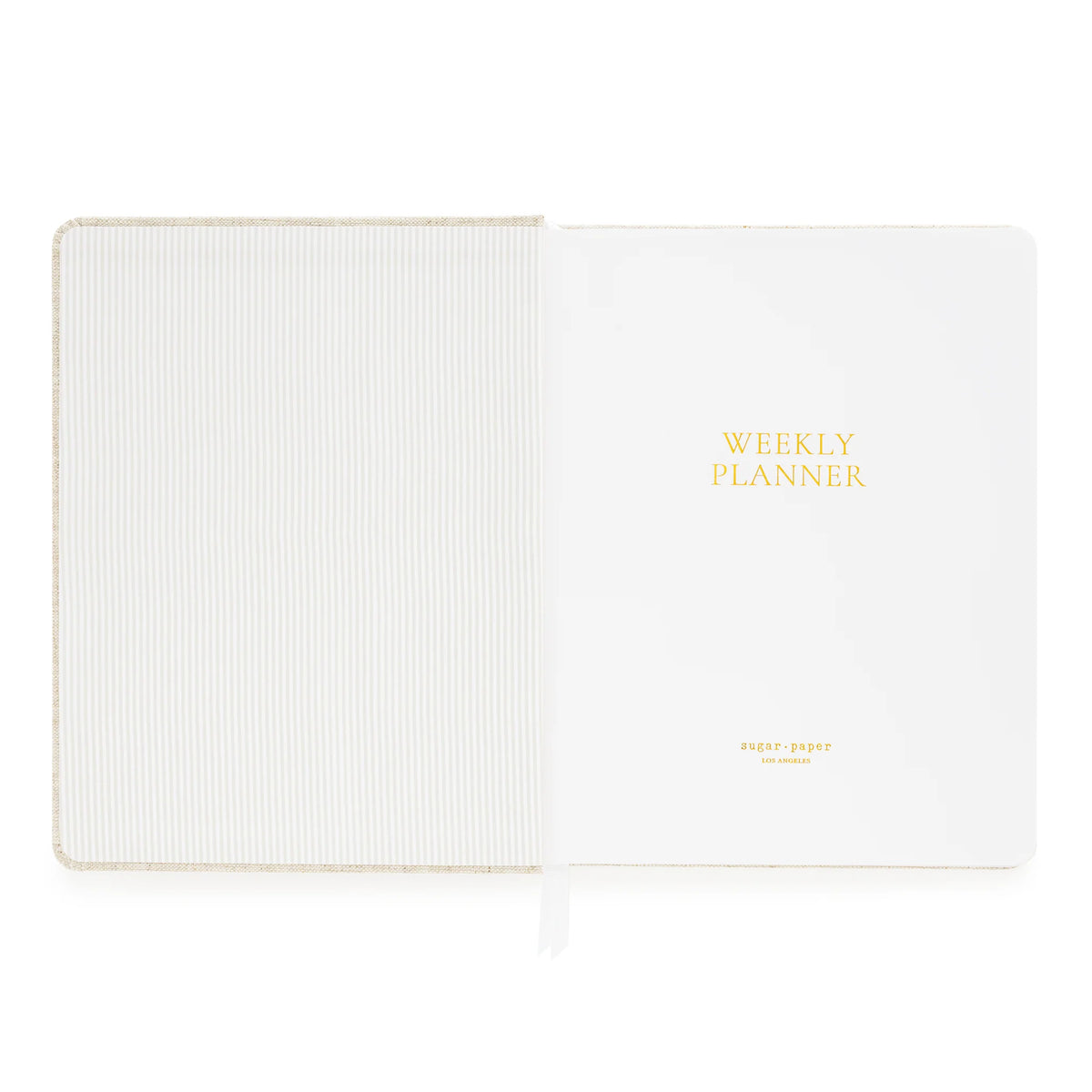 Sugar Paper’s Pale Pink Undated Weekly Planner features a striped inside cover and a title page embossed with “WEEKLY PLANNER” in gold lettering. A white ribbon bookmark keeps your place as you track habits and set goals each week.