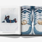 An open book by Assouline titled "Air Jordan" displays a man reclining with a basketball on the left page and a close-up of blue and white Air Jordan sneakers featuring gold lace charms on the right page.