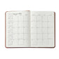 The Graphic Image 2026 Daily Journal Planner Collection features an open diary displaying January 2025’s monthly calendar, a notes section, and small reference calendars for Dec 2024 plus Feb–July 2025.