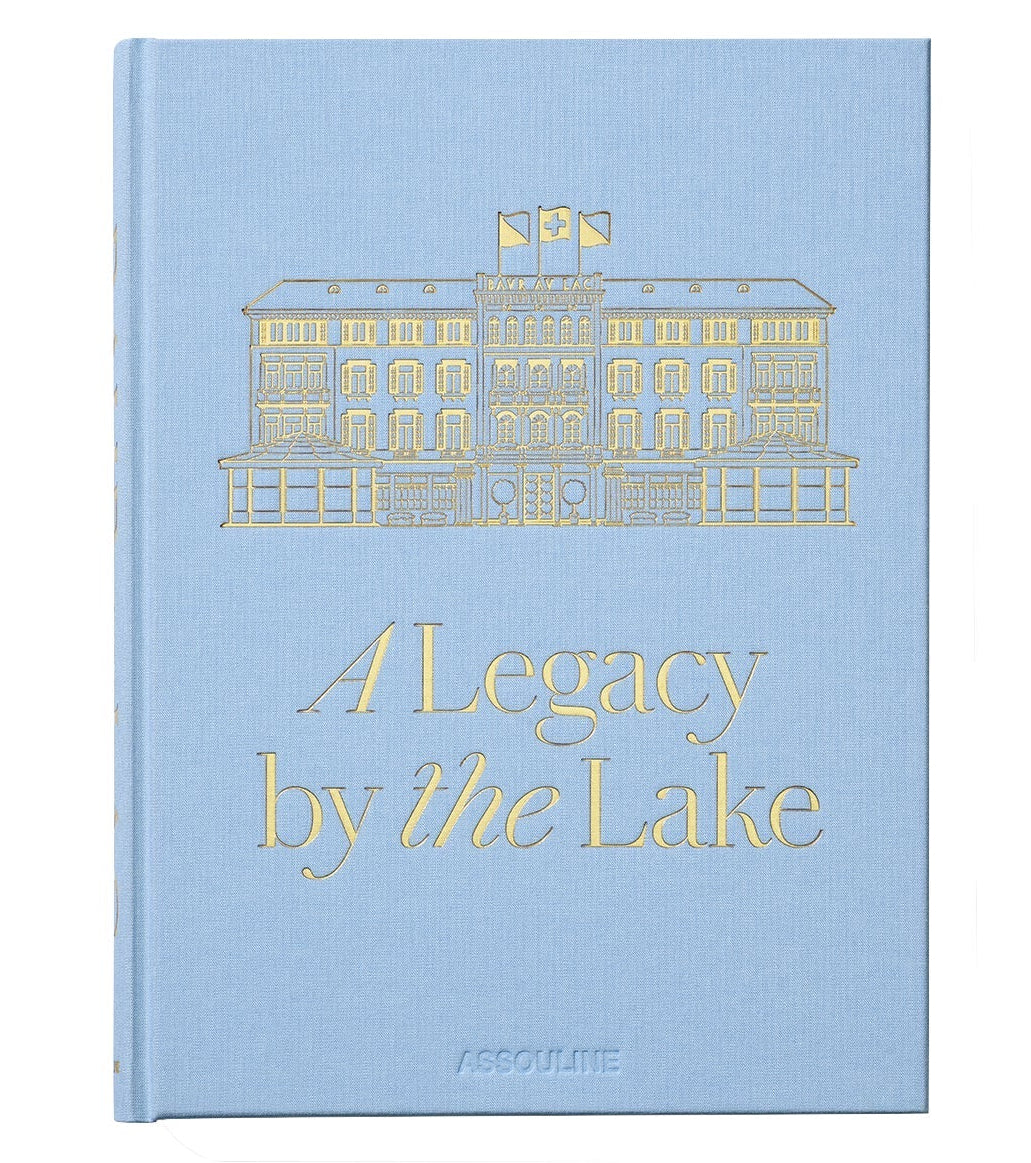 Featuring a light blue cover with a gold illustration of a building, Baur Au Lac: A Legacy by the Lake by Assouline celebrates the storied history of Zurich’s renowned luxury hotel, Baur au Lac.