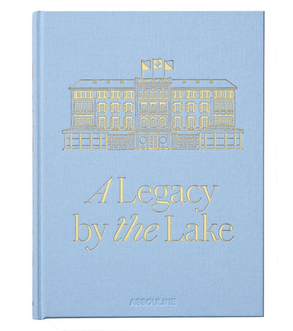 Featuring a light blue cover with a gold illustration of a building, Baur Au Lac: A Legacy by the Lake by Assouline celebrates the storied history of Zurich’s renowned luxury hotel, Baur au Lac.