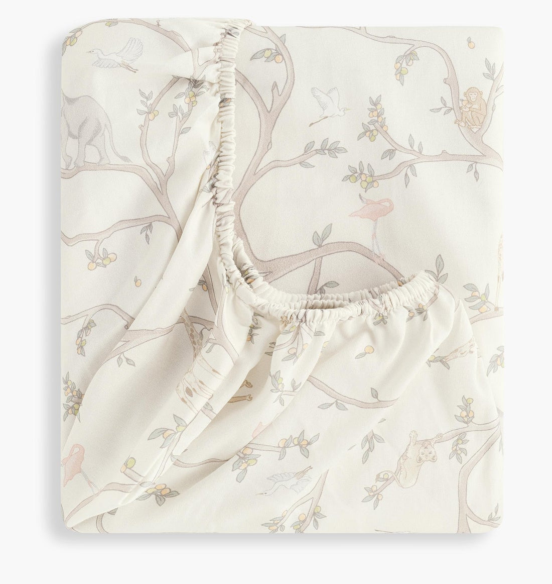 The Gooselings Animal Parade Ivory Crib Sheet is a folded fitted crib sheet made from cotton sateen, featuring a soft pastel animal and tree branch pattern on a light background.