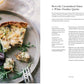 A plate of broccoli, caramelized onion, and white cheddar quiche with mixed greens sits next to a recipe text from Chronicle Books' cookbook "Around Our Table: Wholesome Recipes to Feed Your Family and Friends.