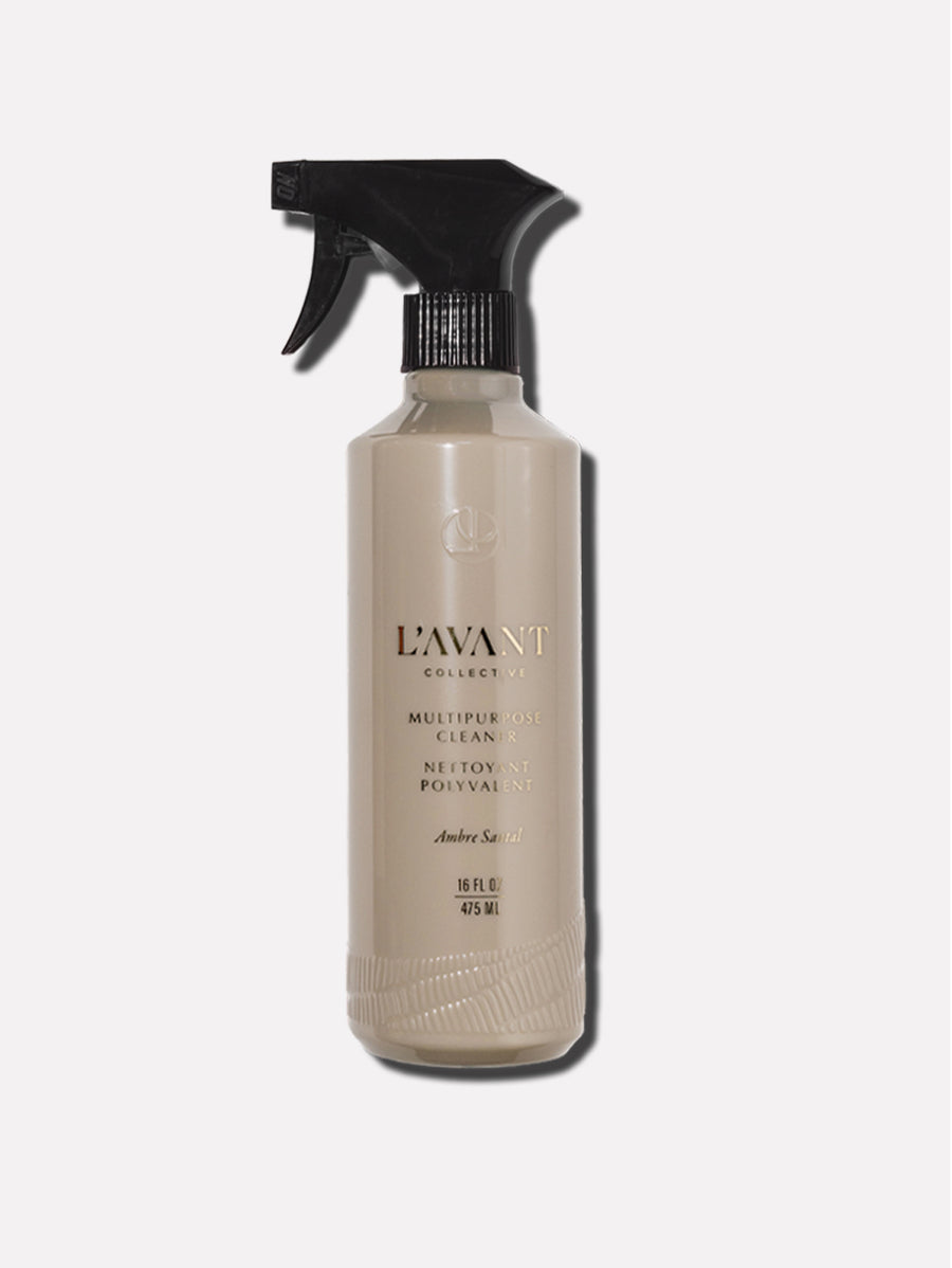 Beige L’Avant Collective Ambre Santal multipurpose cleaner spray bottle with a black trigger nozzle.