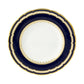 A round Royal Crown Derby Ashbourne Navy plate with a dark blue scalloped border, gold trim, and a white center featuring a delicate gold leaf pattern—an elegant example of British craftsmanship.