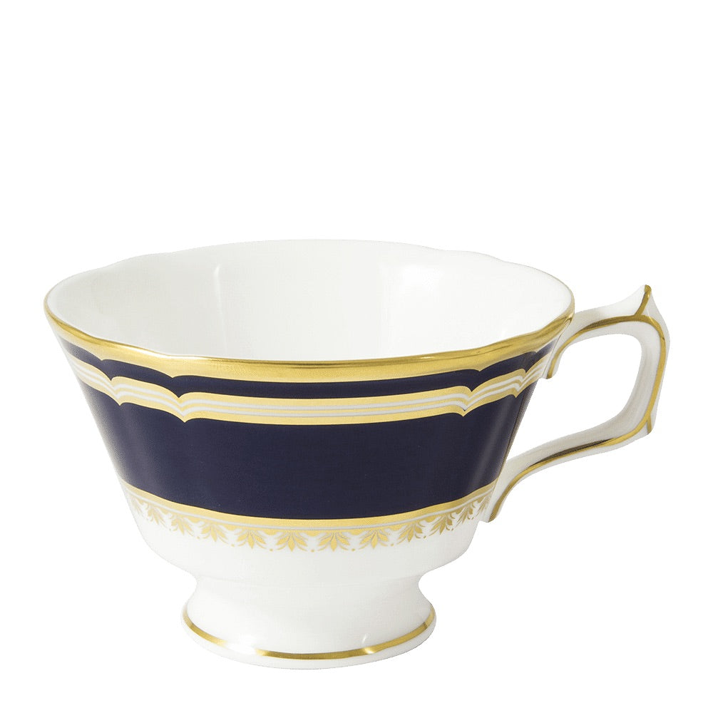 The Ashbourne Navy Dinnerware Collection by Royal Crown Derby features a white fine bone china teacup with a fluted rim, blue band, and gold trim—exemplifying distinguished British craftsmanship.