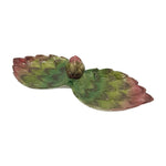 The Les Ottomans Artichoke Decor and Serveware Collection features a lotus-shaped ceramic serving dish with two leaf sections and a bud center in green, pink, and brown—hand-painted in Italy.