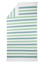 The Amado Beach Towel by Matouk features green, blue, and white horizontal stripes with short white fringe at both ends—ideal for relaxing poolside or seaside.