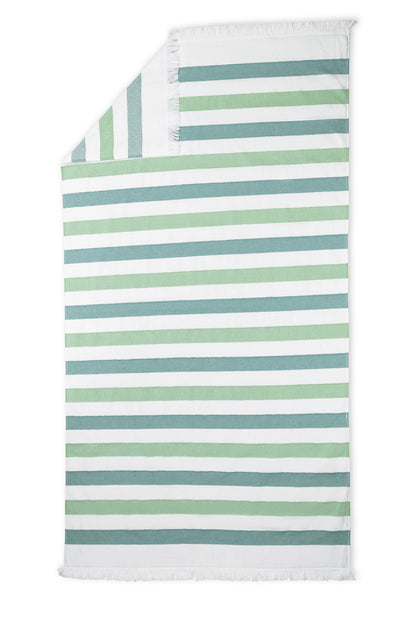 The Amado Beach Towel by Matouk features green, blue, and white horizontal stripes with short white fringe at both ends—ideal for relaxing poolside or seaside.