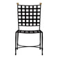 The Amalfi Dining Side Chair in Slate by Janus et Cie features a black metal frame with a square grid backrest and seat, gold sphere finials, and offers an elegant stainless steel outdoor seating option inspired by the iconic Amalfi line.