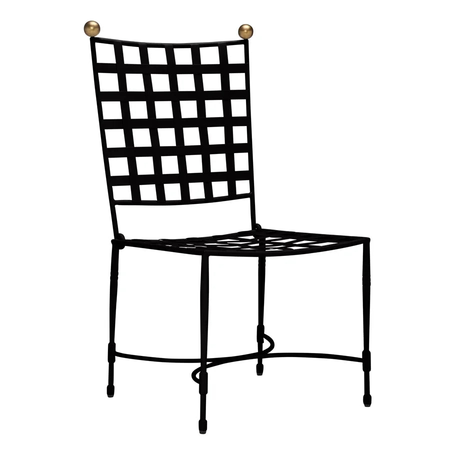 The Amalfi Dining Side Chair in Slate by Janus et Cie features a grid-patterned metal design with gold spheres on the backrest—an elegant outdoor piece inspired by modern stainless steel furniture.