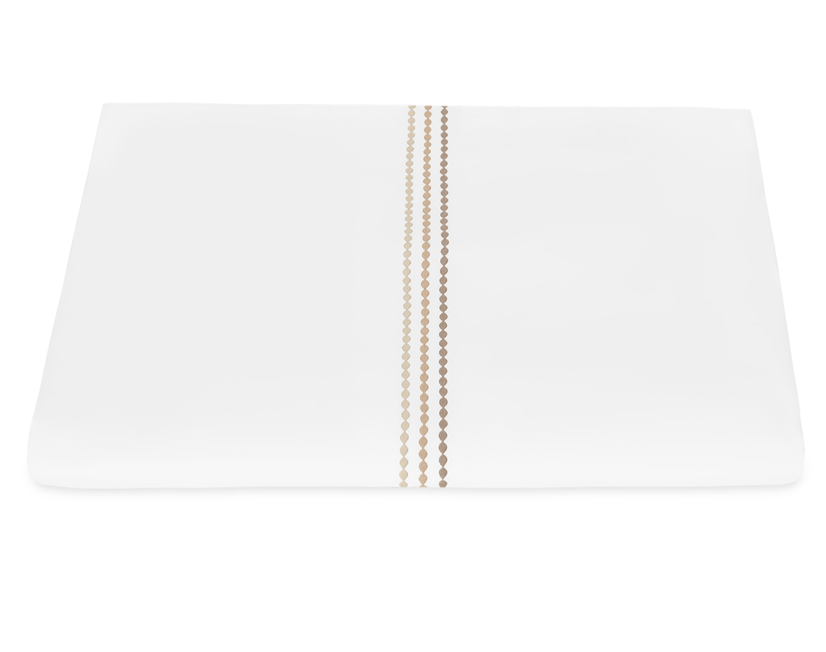 The Matouk Amara Pearl Bedding Collection in Beach features an elegant white rectangular design with three vertical gold dotted lines embroidered near the center, shown on a white background.