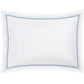 A rectangular white pillowcase from the Amara Triple Pearl Bedding Collection by Matouk, crafted from luxurious Amara sateen and featuring an elegant triple embroidered border in blue and black dots, is displayed on a plain white background.