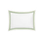 Matouk’s Amara Triple Pearl Bedding Collection features a white rectangular pillow adorned with a green and gold dotted triple pearl embroidered border, crafted from luxurious Amara sateen and set against a pristine white background.