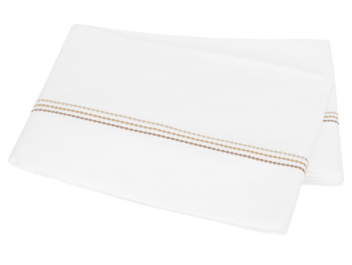 A folded white sheet from the Amara Pearl Bedding Collection, Beach by Matouk, featuring an elegant sateen finish and two tan embroidered lines, placed on a white background.