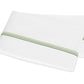 Two folded white pillowcases from the Matouk Amara Triple Pearl Bedding Collection, featuring a green dotted stripe near one edge and an elegant triple pearl embroidered design, placed on a white background.