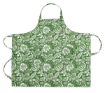 Matouk Linen Apron Collection: green linen apron featuring white floral and leaf Schumacher prints, shown flat with neck and adjustable waist ties extended.