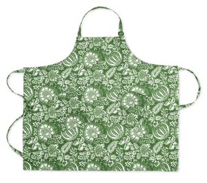 Matouk Linen Apron Collection: green linen apron featuring white floral and leaf Schumacher prints, shown flat with neck and adjustable waist ties extended.