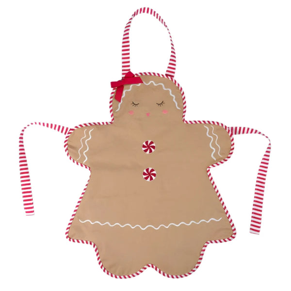 The MON AMI Gingerbread Apron by Mon Ami is styled to resemble a gingerbread girl cookie, featuring striped red and white trim, two peppermint buttons, icing details, and a red bow—making it an ideal Christmas gift for holiday cookie enthusiasts.